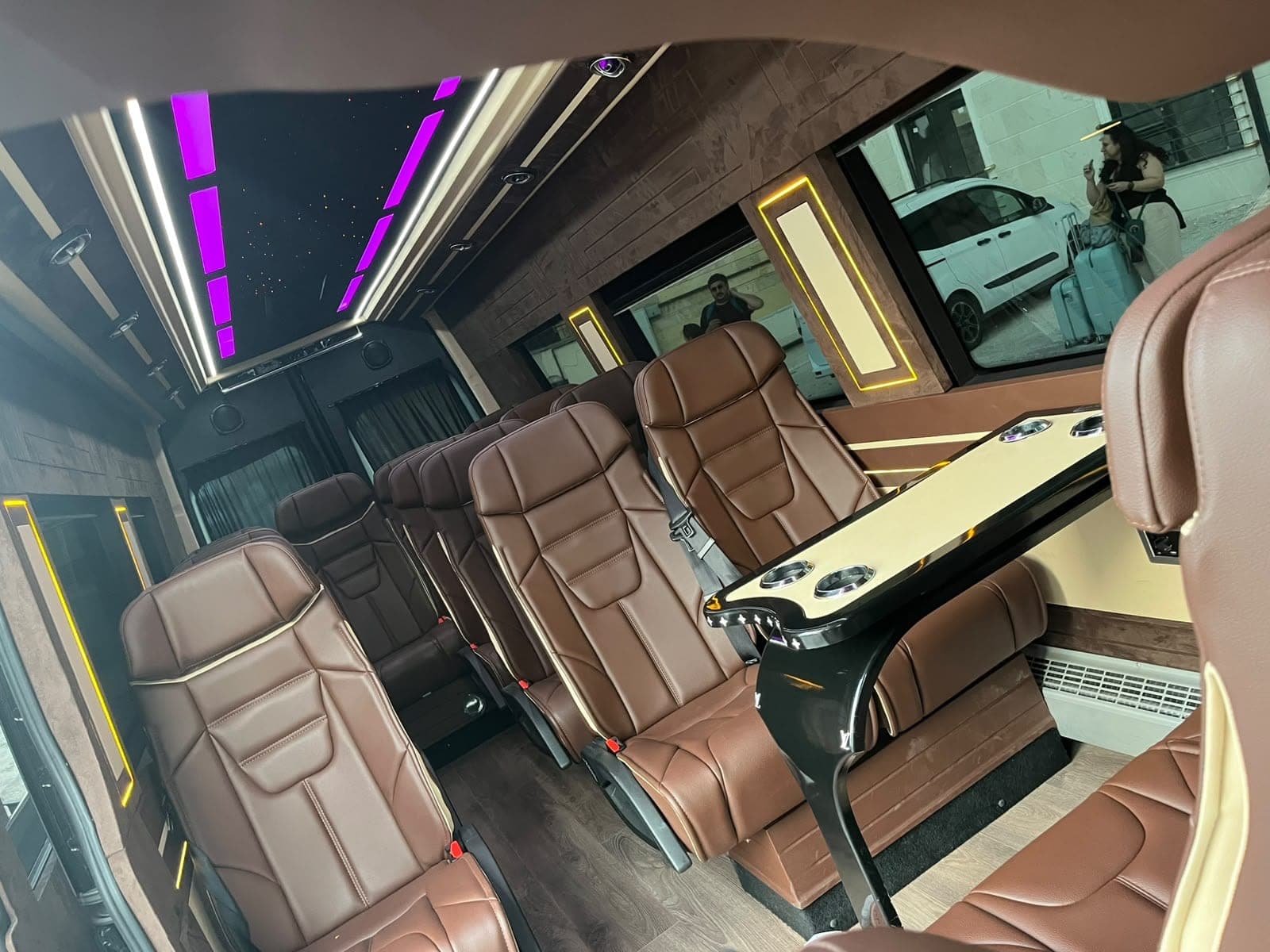 Leather seats around a table in our VIP minibus