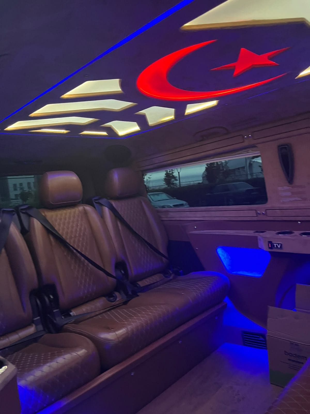 Star-and-crescent ceiling lighting and leather seats in our VIP vehicle